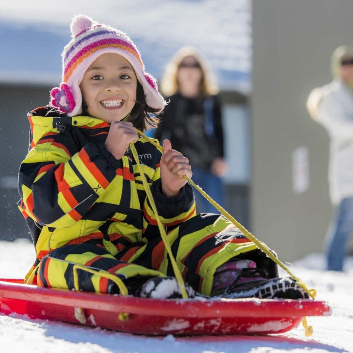 Tobogganing on the Pea Shooter slope at Dinner Plain